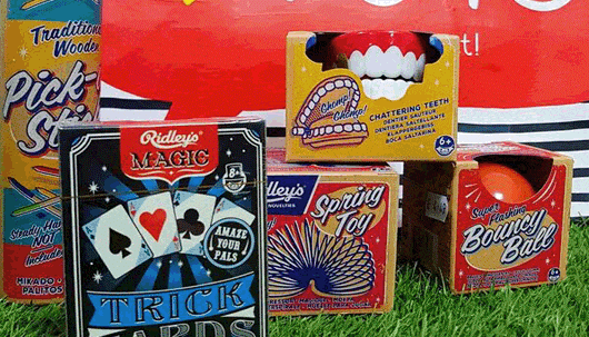 A selection of vintage toys, including playing cards and a bouncy ball
