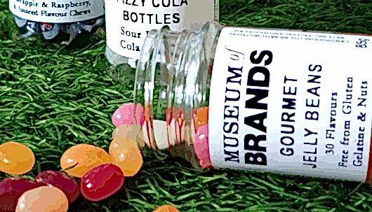 Colourful jelly bean sweets spilling out of a jar that reads Museum of Brands Gourmet Jelly Beans